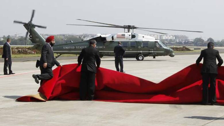 Winds blow away red carpet laid out for Obama