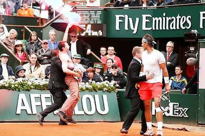 Protesters, one letting off a flare, interrupt French Open final
