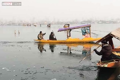 In pics: Shikaras struggle to move in frozen Dal lake in Srinagar