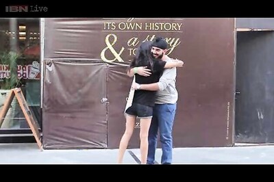 Young Japanese man promoting peace gives free hugs