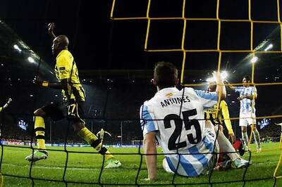 Late goal drama leaves Dortmund dizzy, Malaga fuming