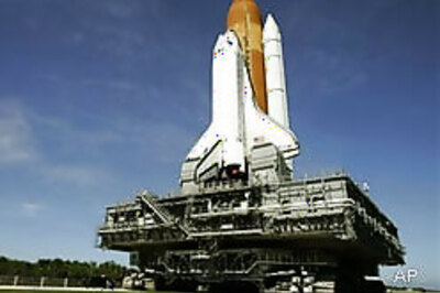 Shuttle Atlantis rolls back to hangar